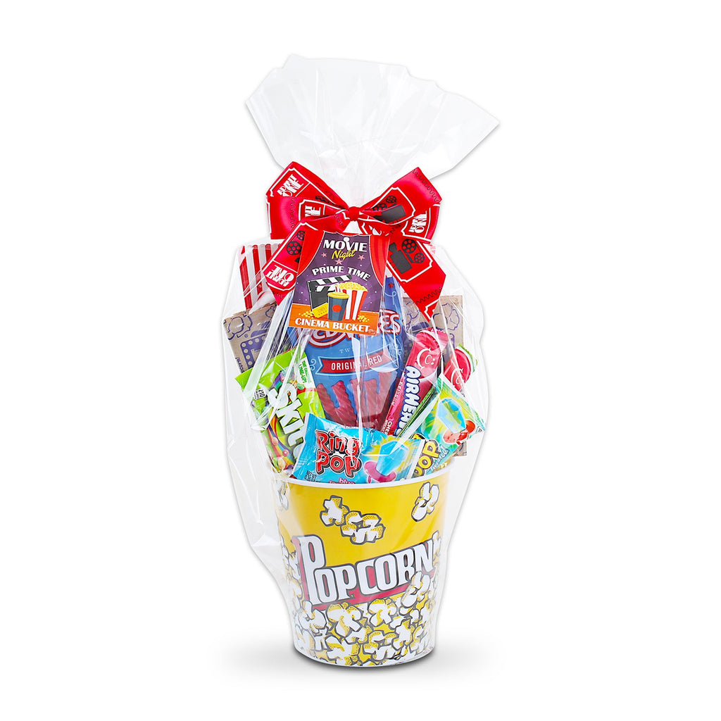 Clear gift bag holding popcorn and candy packs with a large red bow.