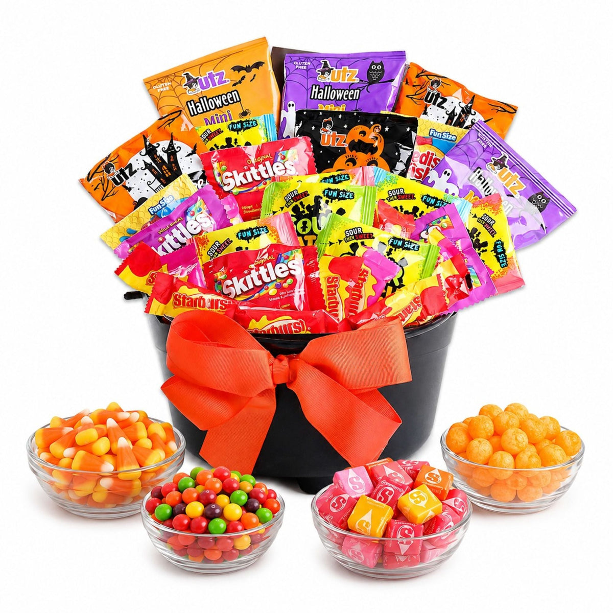 Halloween candy gift basket in black bucket with orange bow and assorted wrapped treats