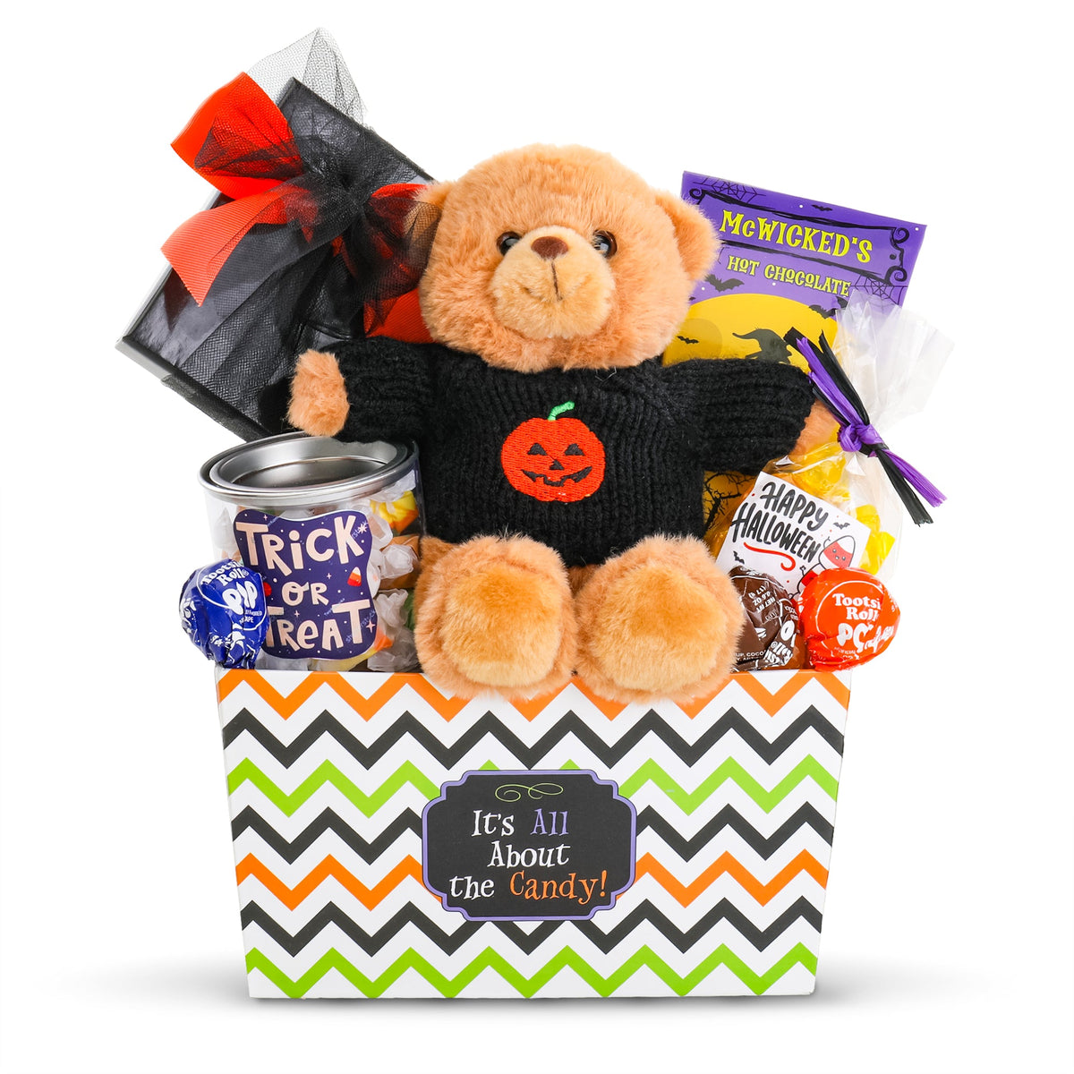 Halloween gift basket with plush bear, orange pumpkin patch, candy packs, and wrapped treats