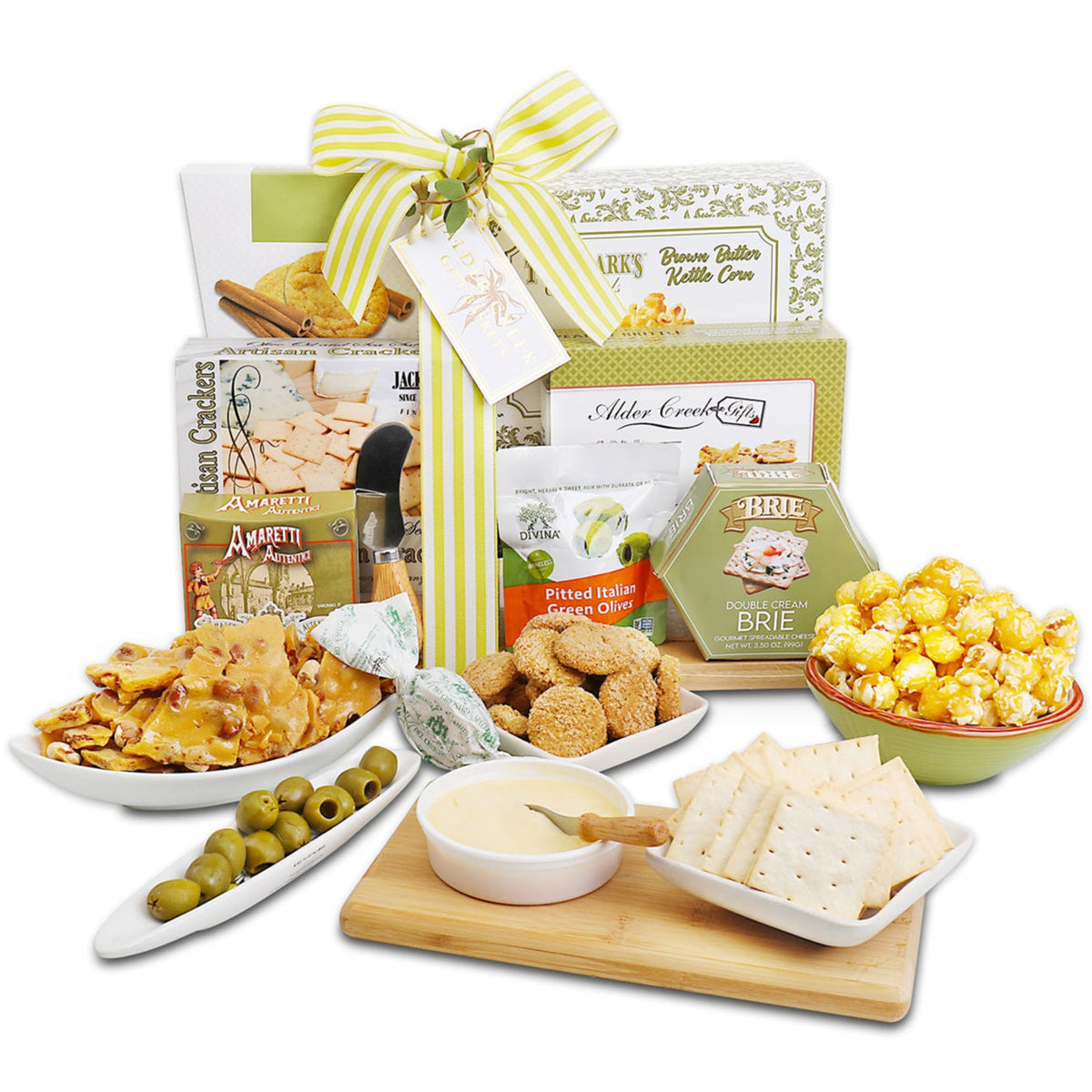 Charcuterie gift basket assortment with crackers, olives bowl, and serving board on white background