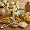 Charcuterie gift basket with crackers, olives, and serving board, tied with green striped bow