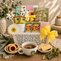Assorted cookie and tea gift basket with biscuits, tea cup, and yellow bow