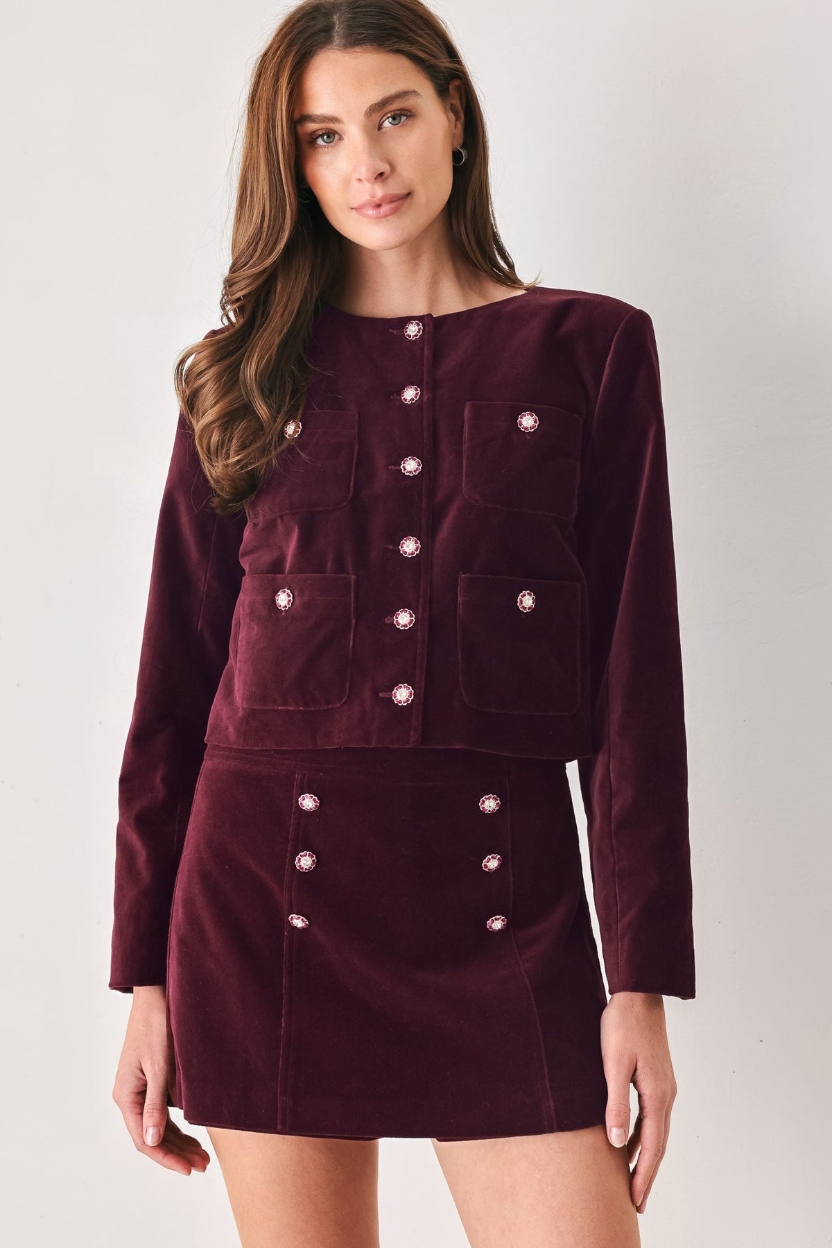 Burgundy velvet cropped jacket with jeweled button front and patch pockets