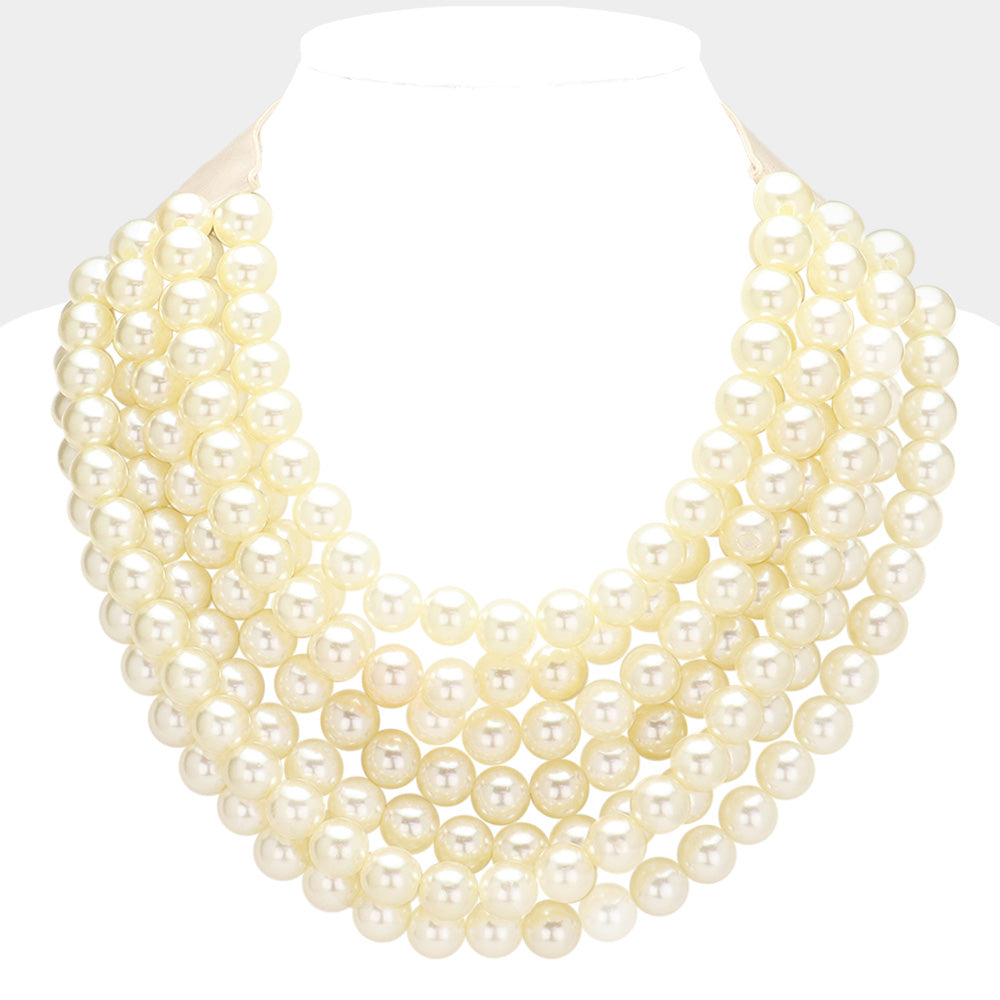 Ivory pearl-look multi-strand beaded statement necklace with layered round beads.