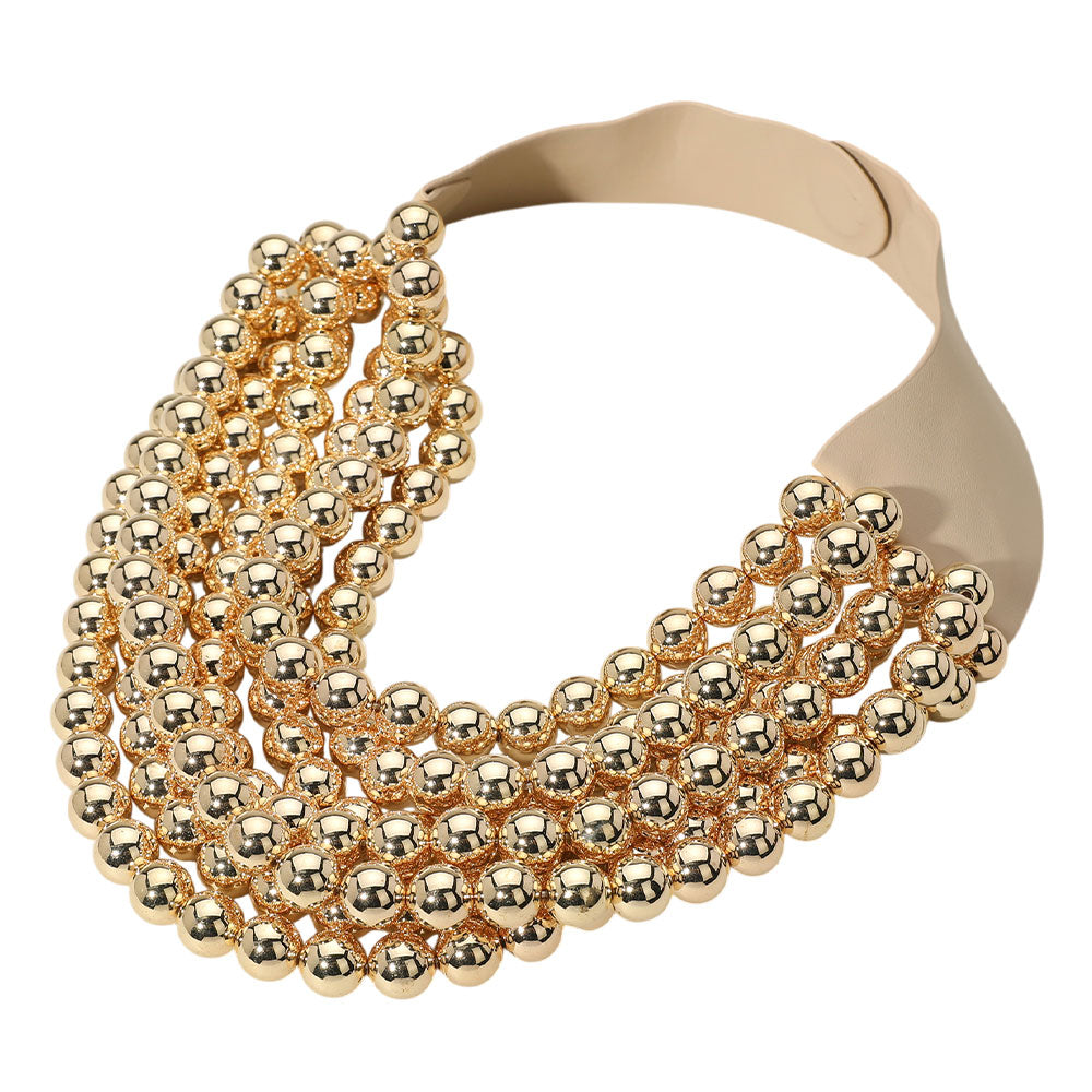 Gold multi-strand beaded statement necklace with layered metallic round beads.
