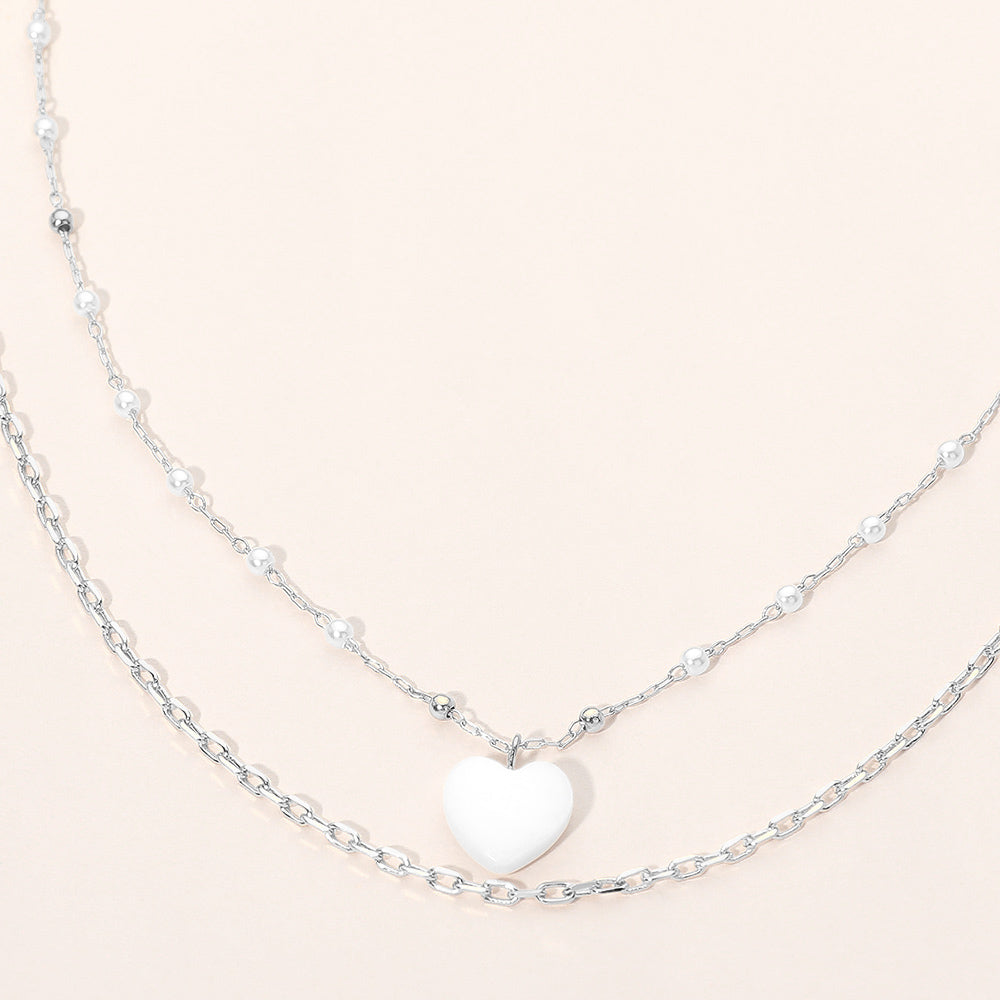 Layered necklace with cream mother-of-pearl heart pendant on silver-tone chains
