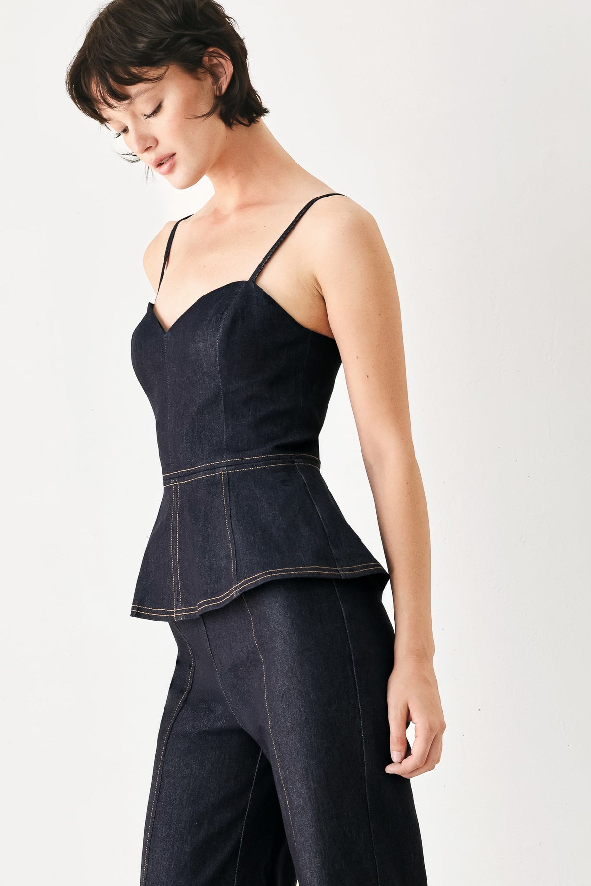 Dark denim jumpsuit with peplum waist and wide legs, thin spaghetti straps