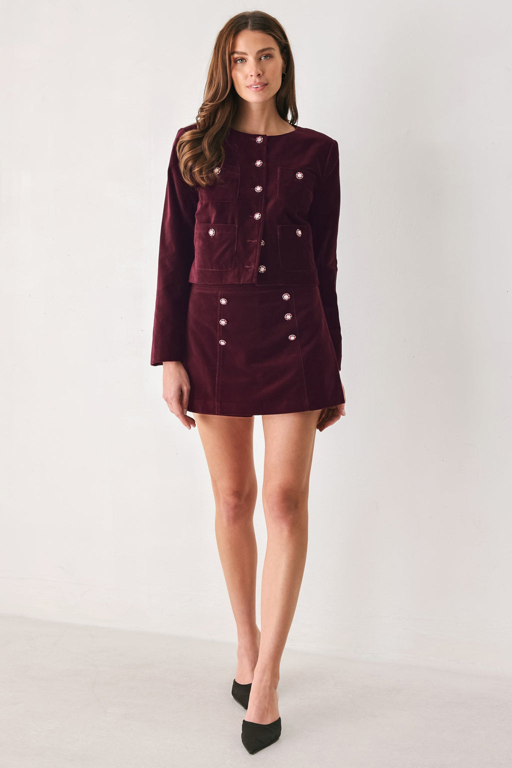 Burgundy velvet skort with decorative buttons and patch pockets