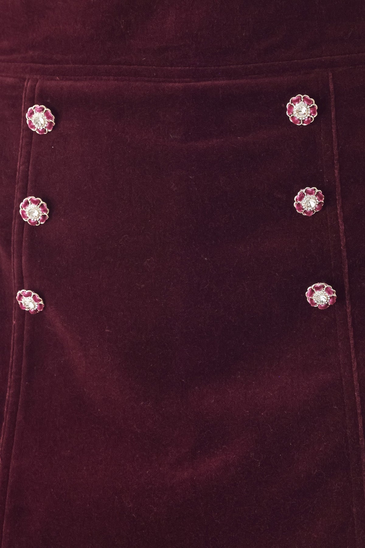 Burgundy velvet skort close-up of floral decorative buttons