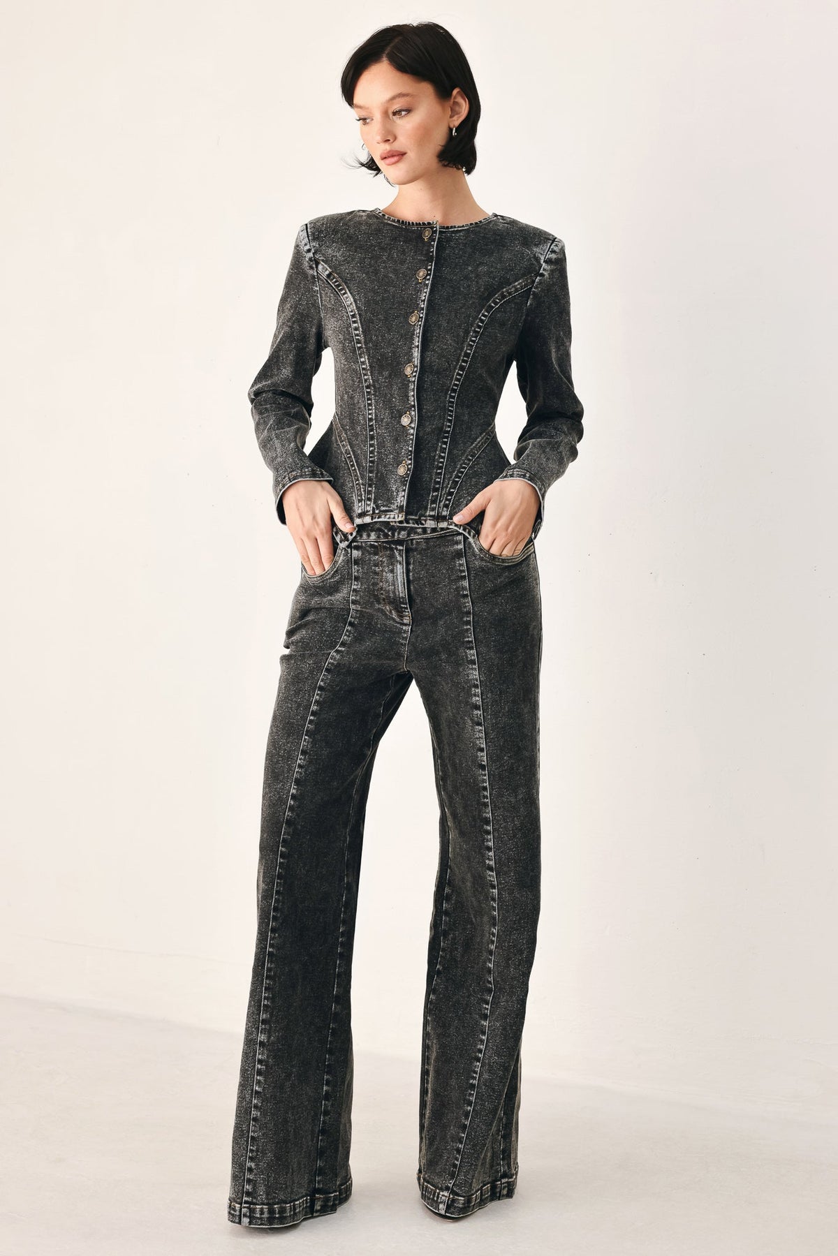 Black wash denim pants with long wide legs and crossover front panel detail
