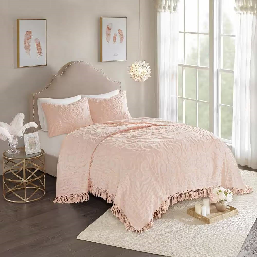 Pink blush chenille bedspread with fringe hem and ornate swirling damask design