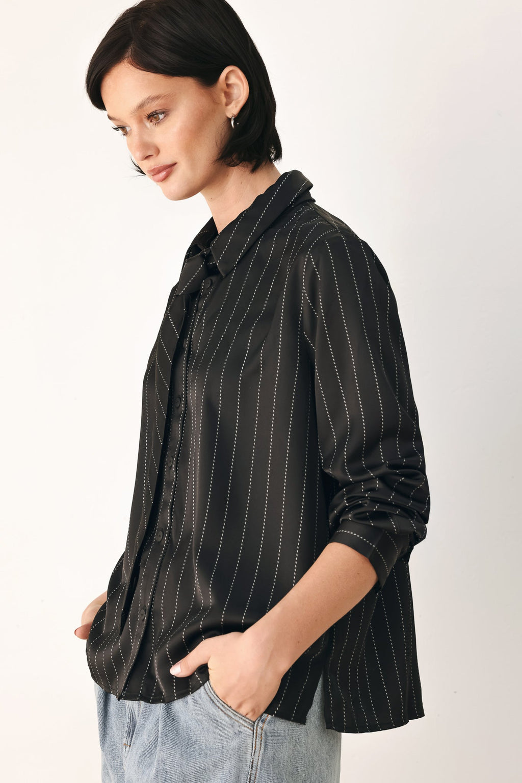 Black striped tie-front shirt top side view with long sleeve cuff