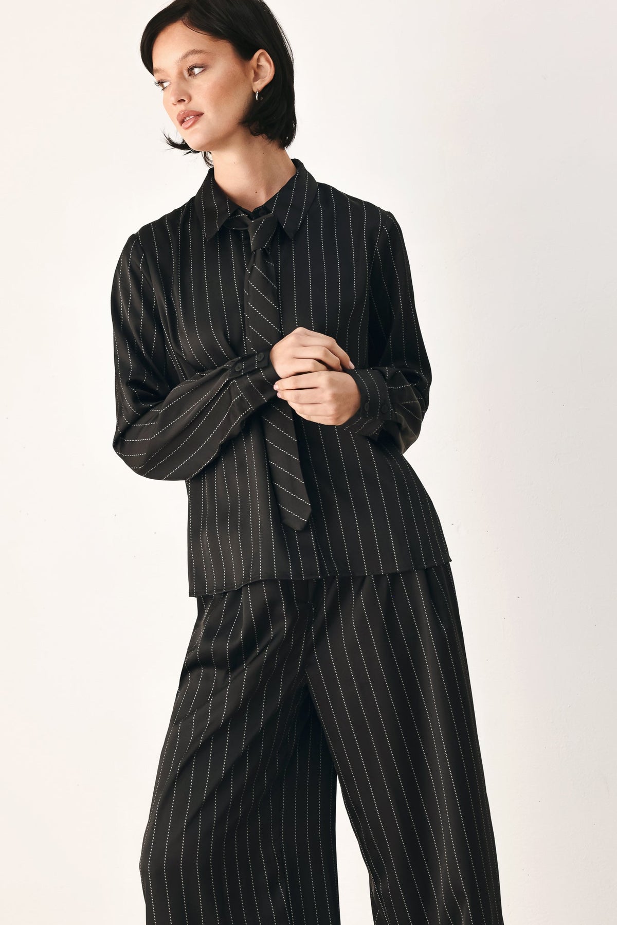 Black striped tie-front shirt top front view with neck tie and button closure