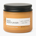 Amber face moisturizer jar with black lid, labeled with vitamin E and aloe vera