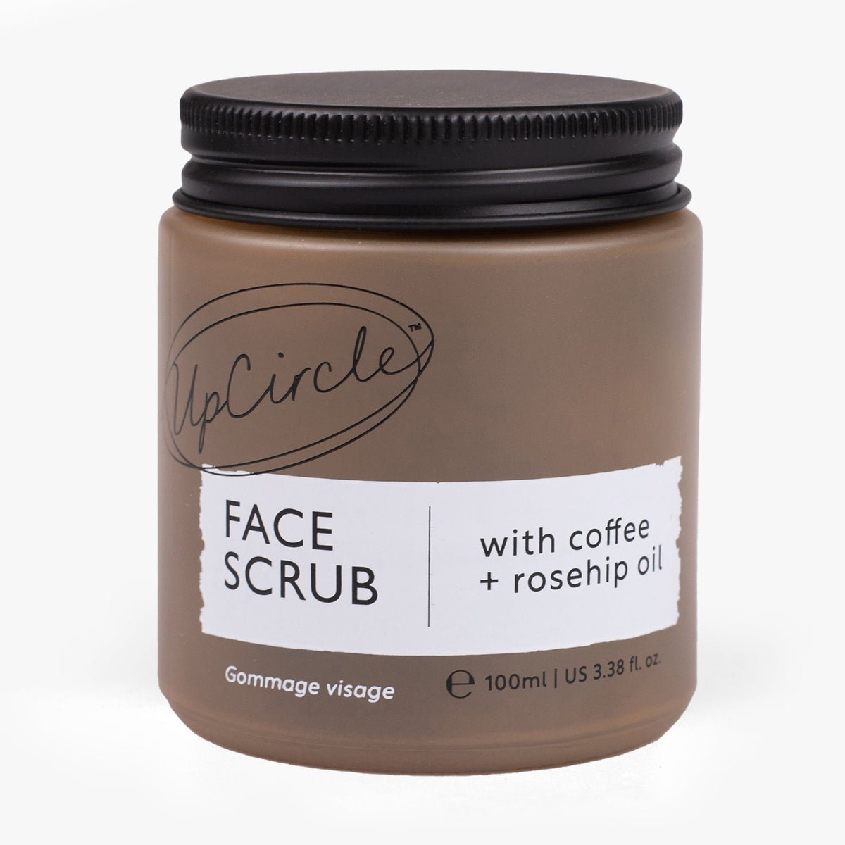 Face scrub jar with dark screw-top lid and label, brown body, coffee + rosehip oil