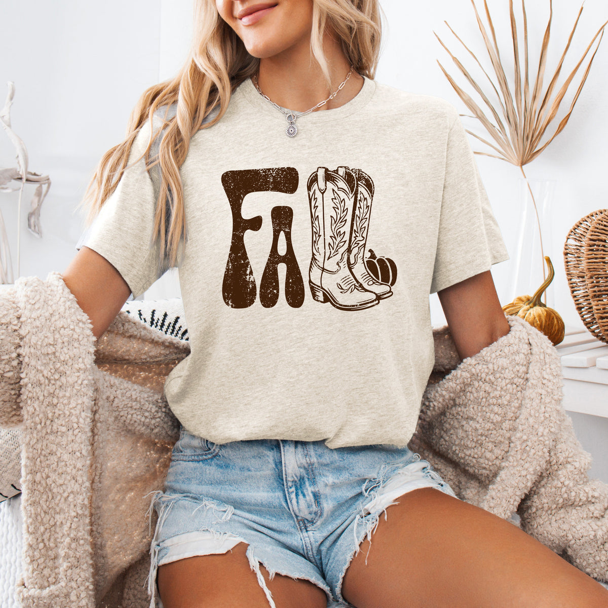 Cream cowboy boots graphic T-shirt with front boot and leaf motif
