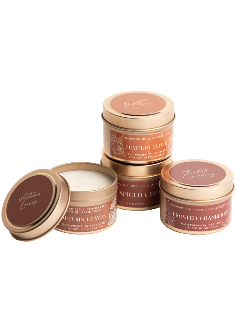 Four candle tins with lids: Pumpkin Clove, Spiced Cider, Roasted Cranberry, Autumn Leaves