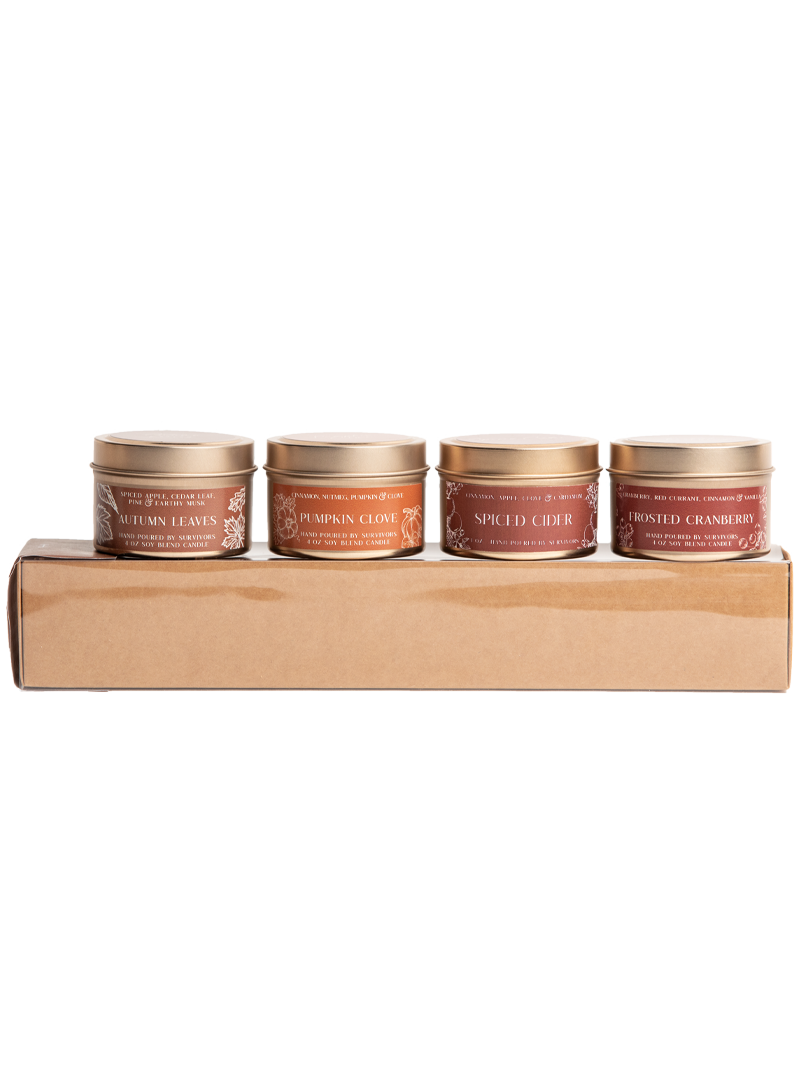 Four upright candle tins on tray: Pumpkin Clove, Spiced Cider, Roasted Cranberry, Autumn Leaves