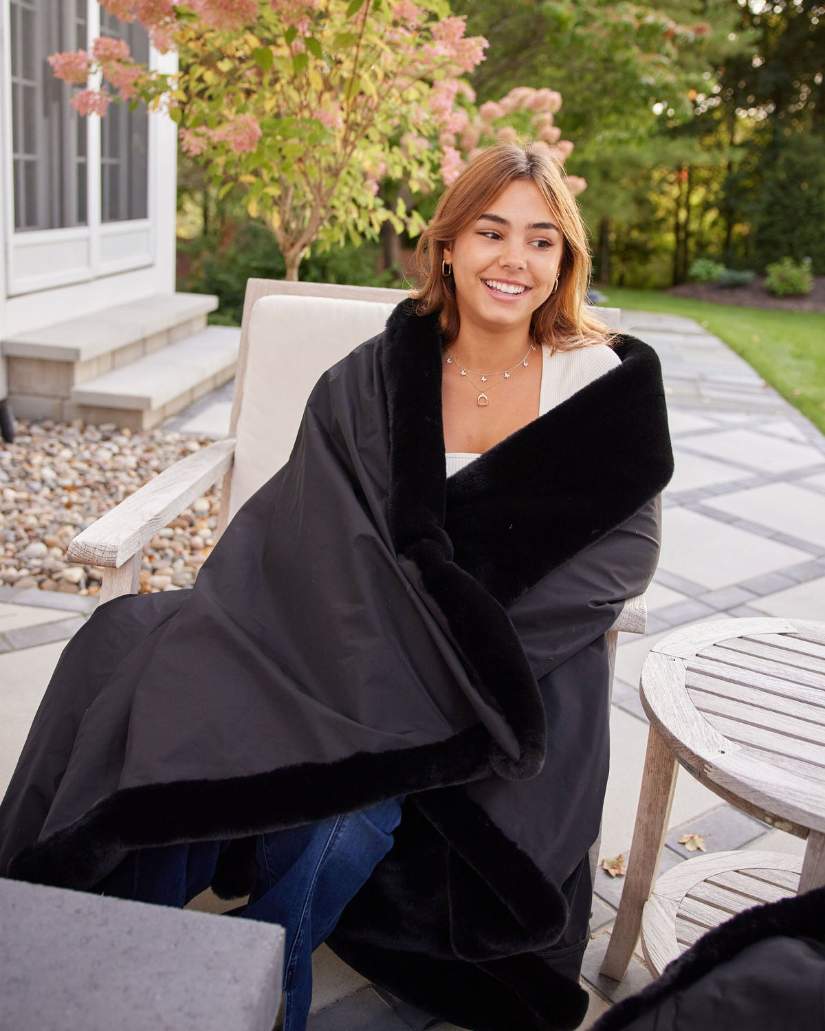 Large outdoor blanket with black outer layer and plush lining.
