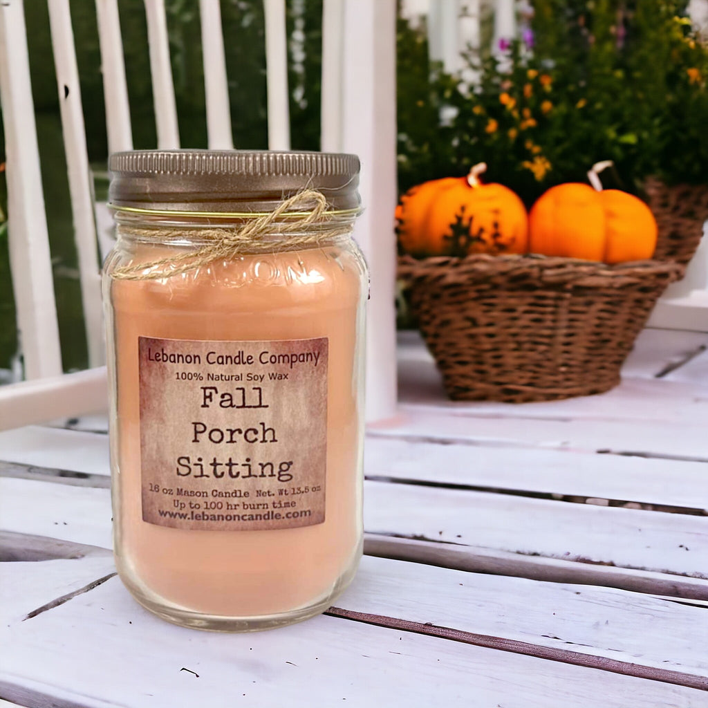 Amber jar candle with Fall Porch Sitting label and twine tied around lid