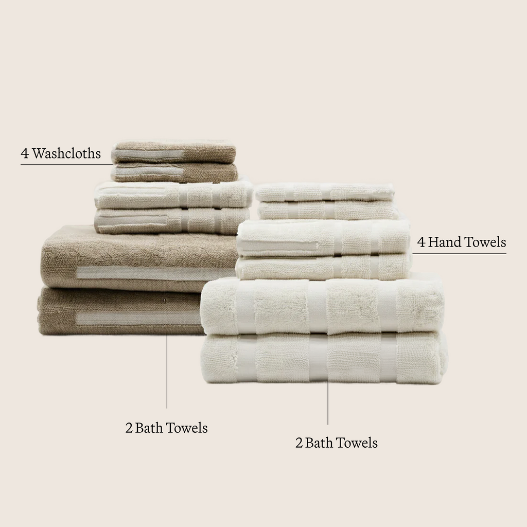 Ecru cotton towel set with multiple folded stacks of washcloths, hand towels, and bath towels