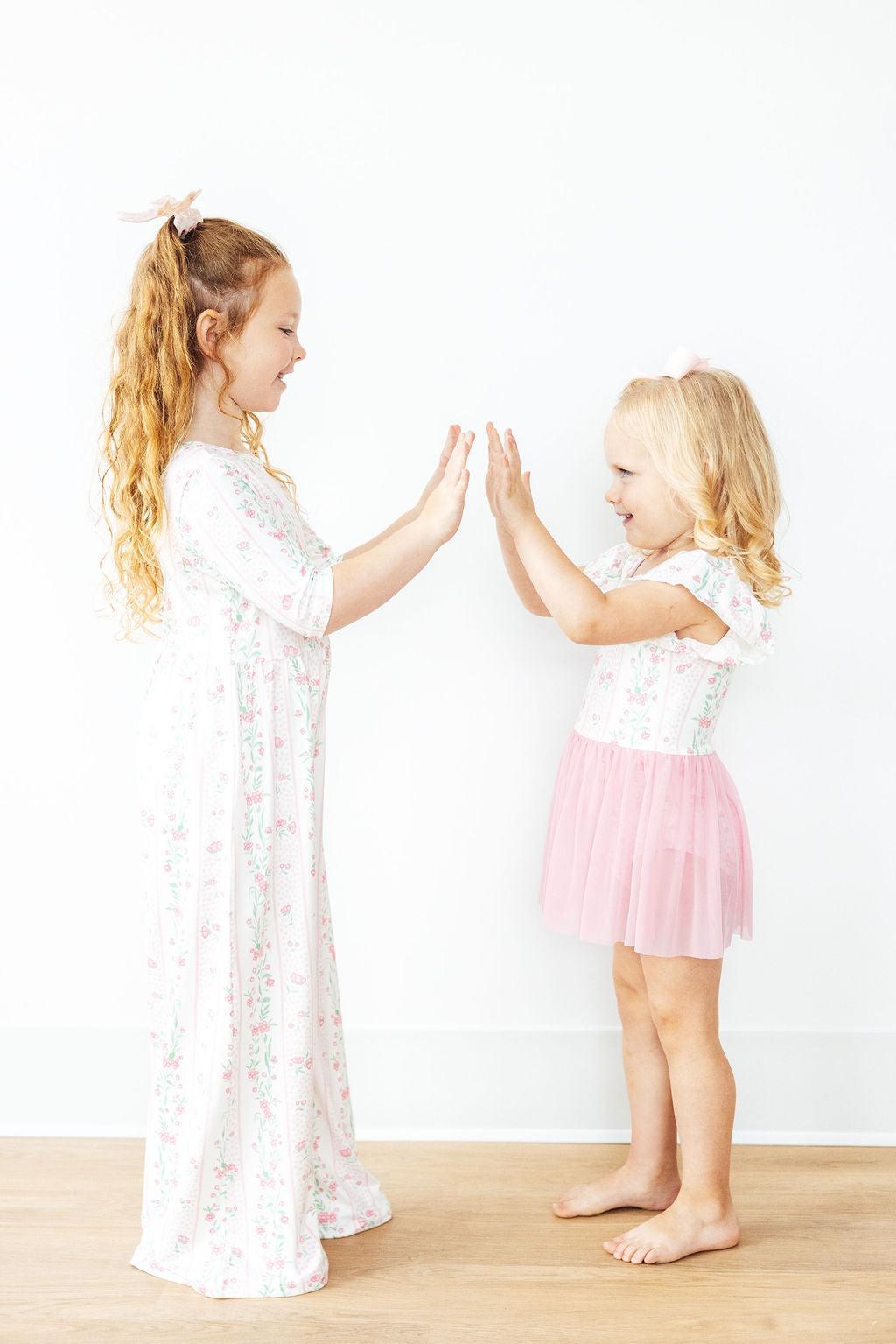 Girls white floral leotard with pink twirl skirt and flutter cuff sleeves