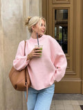 Pink chunky knit sweater with crew neck, long sleeves, and loose fit