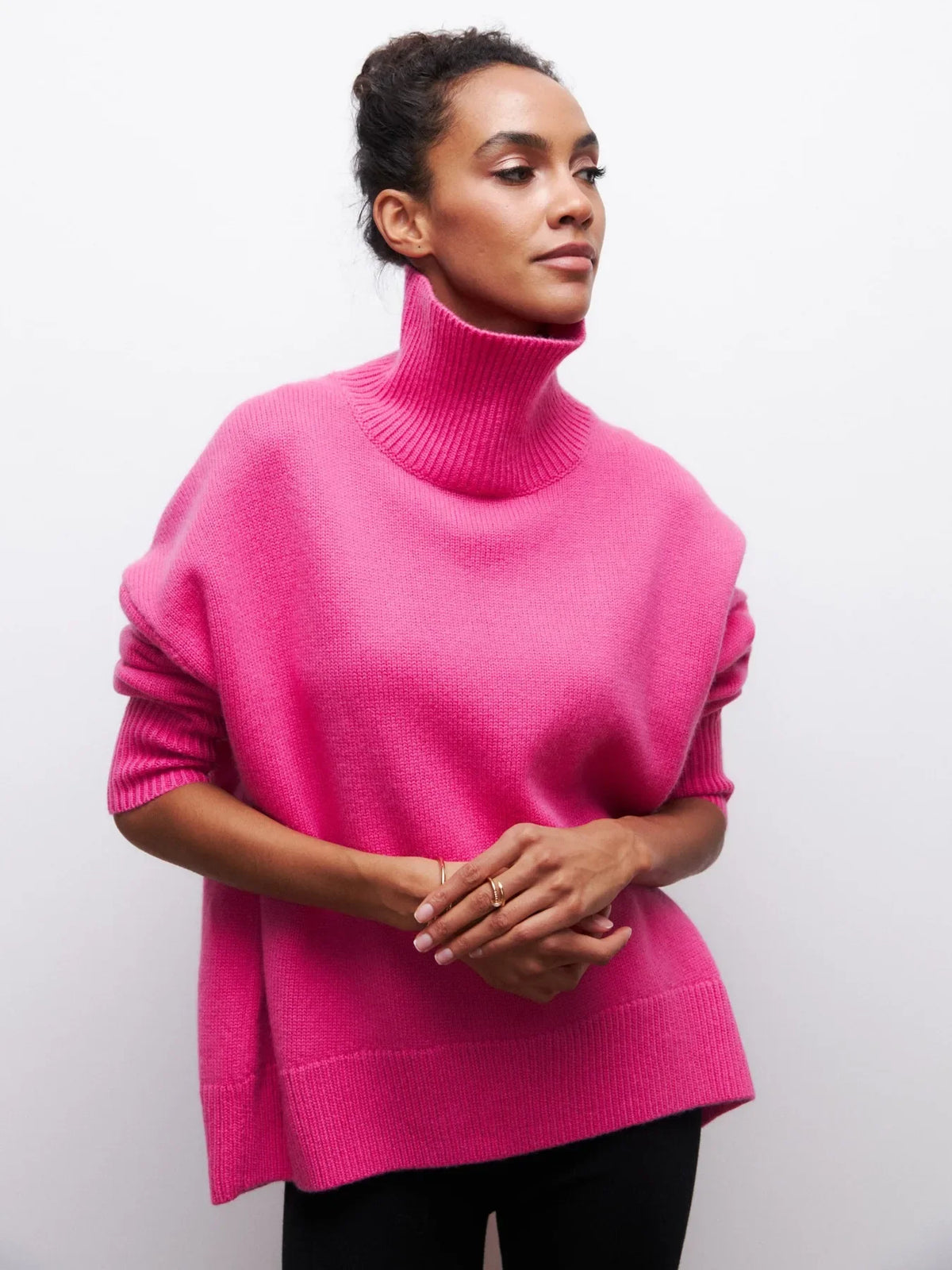 Hot pink knit sweater with ribbed turtleneck, long sleeves, and loose fit