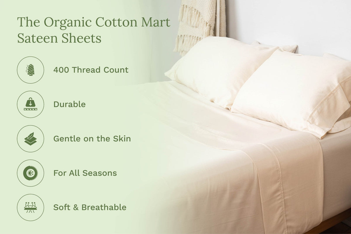 Light cream sateen bed sheets set on a bed, draped over mattress and pillows