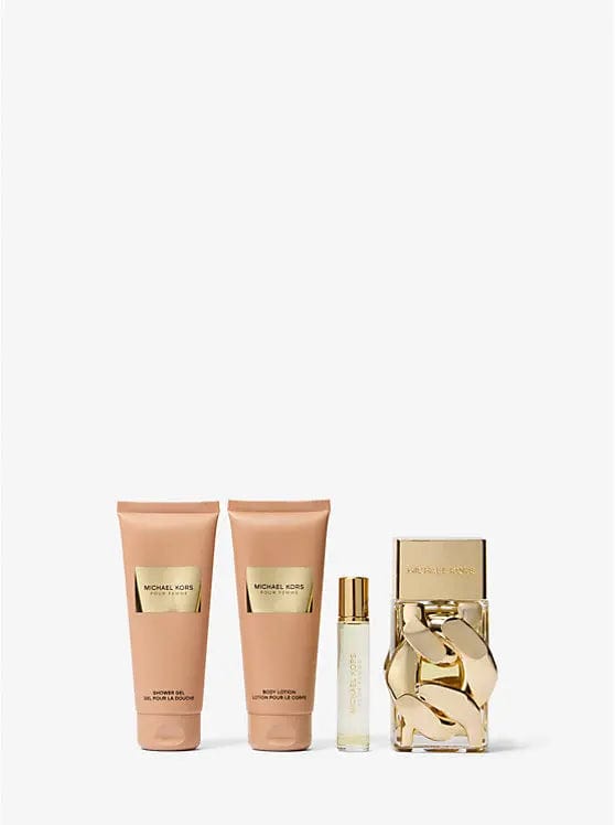 Michael Kors Femme perfume gift set: two lotion tubes, small spray, and glass perfume bottle