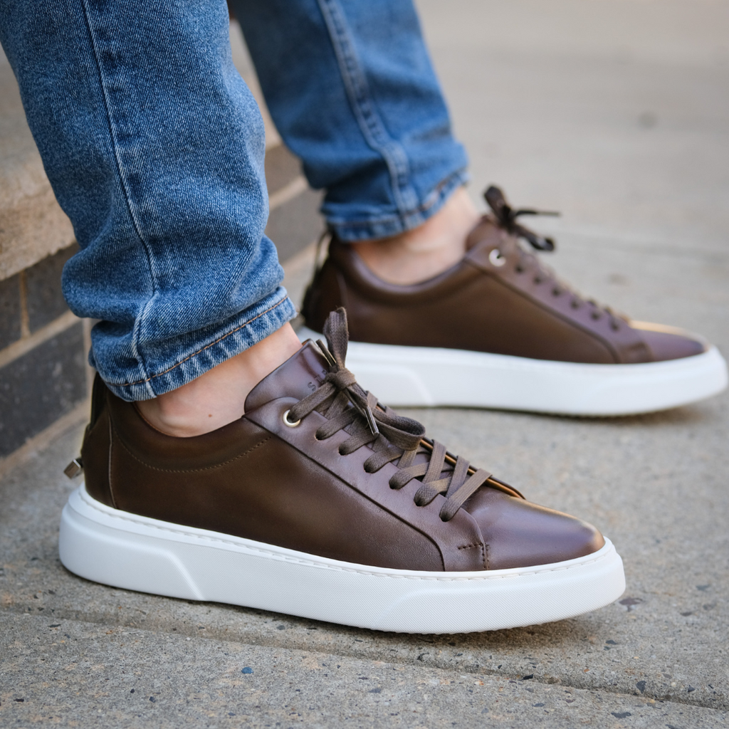 Men's dark brown lace-up leather sneakers with white cushioned sole