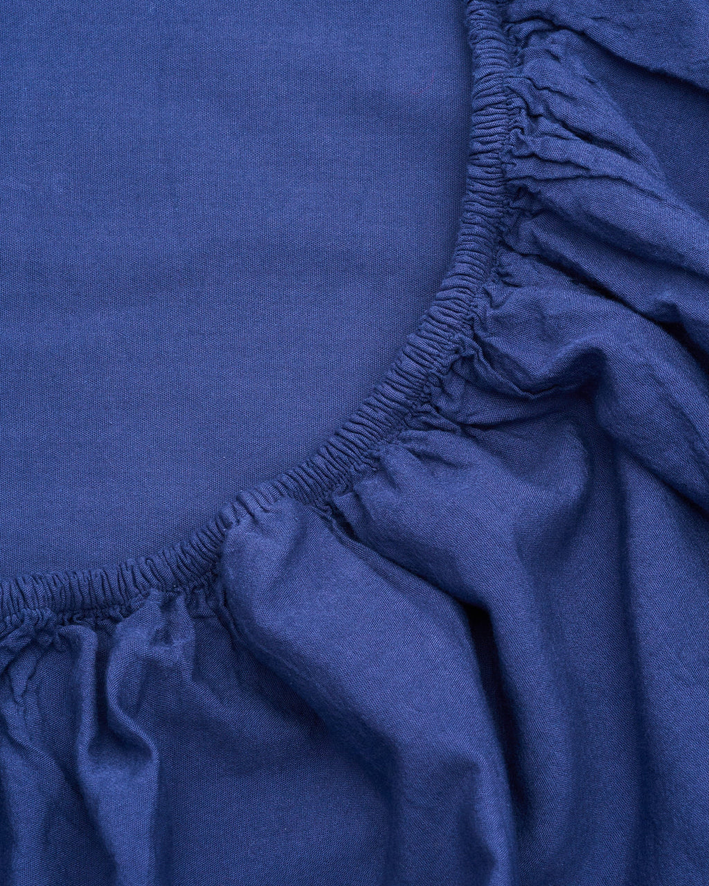 Milk fibre sheet set fitted edge detail, deep blue elastic gathered seam
