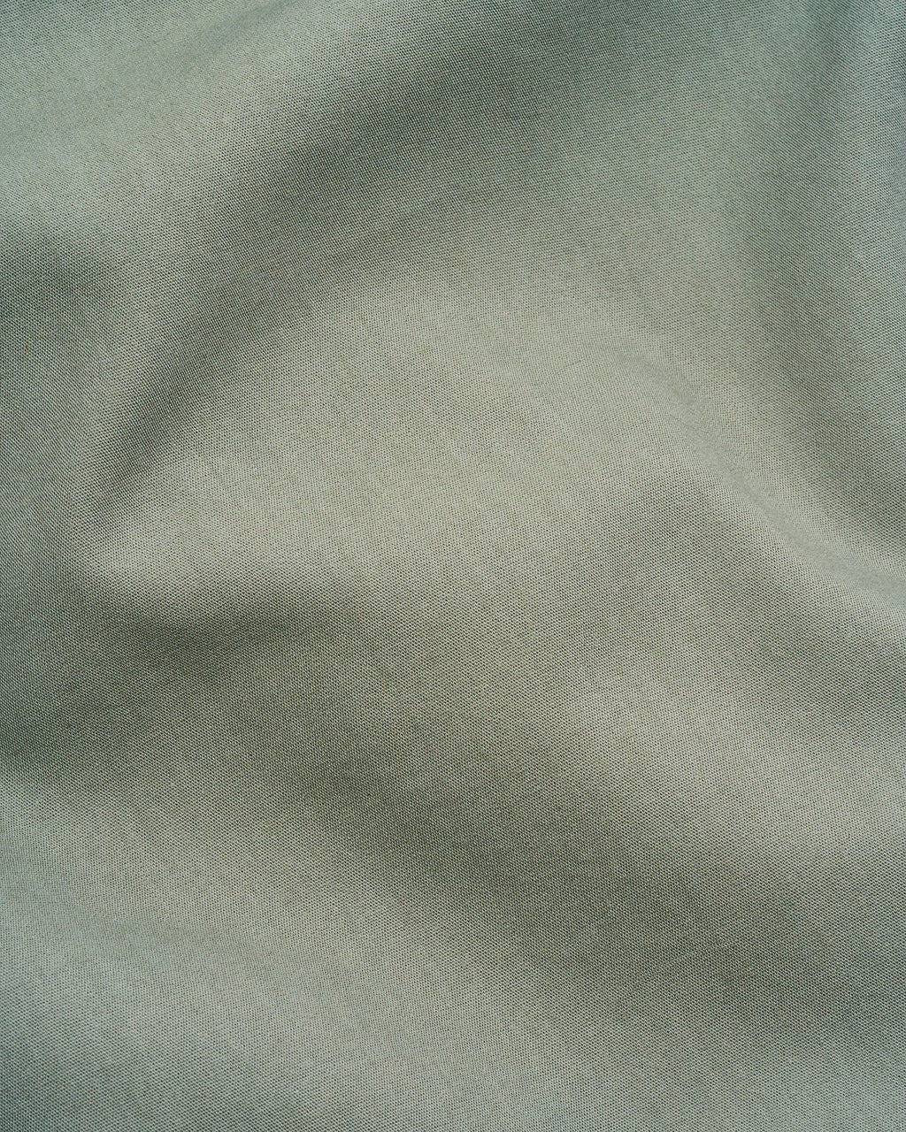 Milk fibre sheet set fabric close-up, dark green microfiber texture