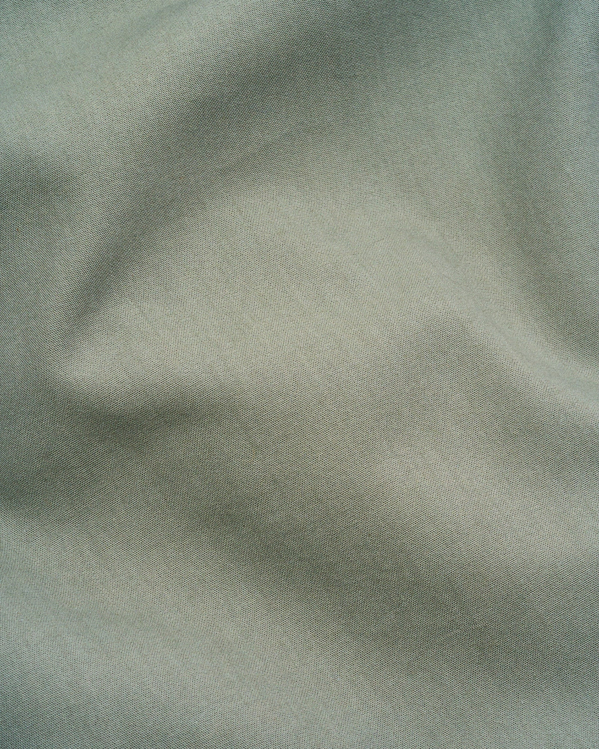 Milk fibre sheet set fabric close-up, dark green microfiber texture