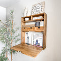 Fold-down wood shelf open like a wall desk with shelves and cubbies