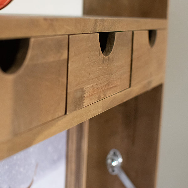 Natural wood drawer fronts with cutout handles on fold-down shelf unit