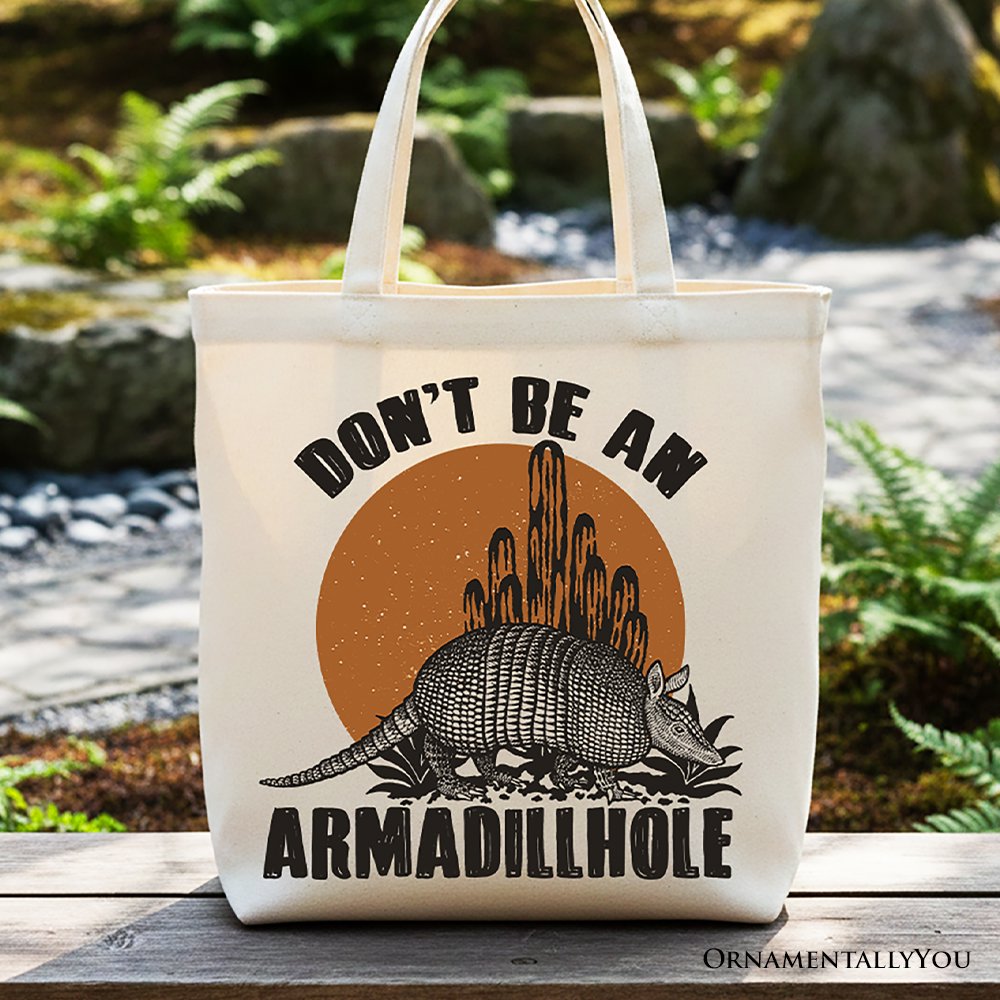 White canvas tote bag with armadillohole graphic and long shoulder handles