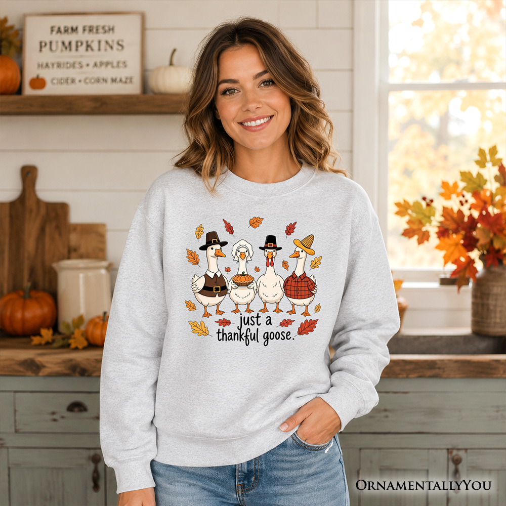 Light gray crewneck sweatshirt with geese graphic and "just a thankful goose" text