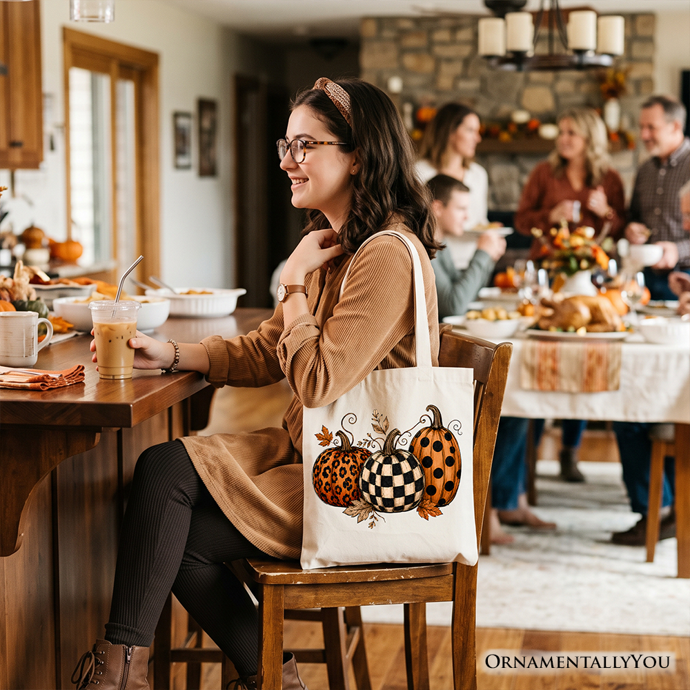 White tote bag with pumpkin leopard checkered design on front panel, long handles