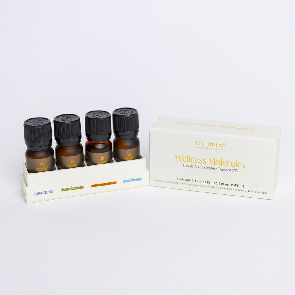 Essential oil set of four amber glass bottles with black ribbed caps, in box