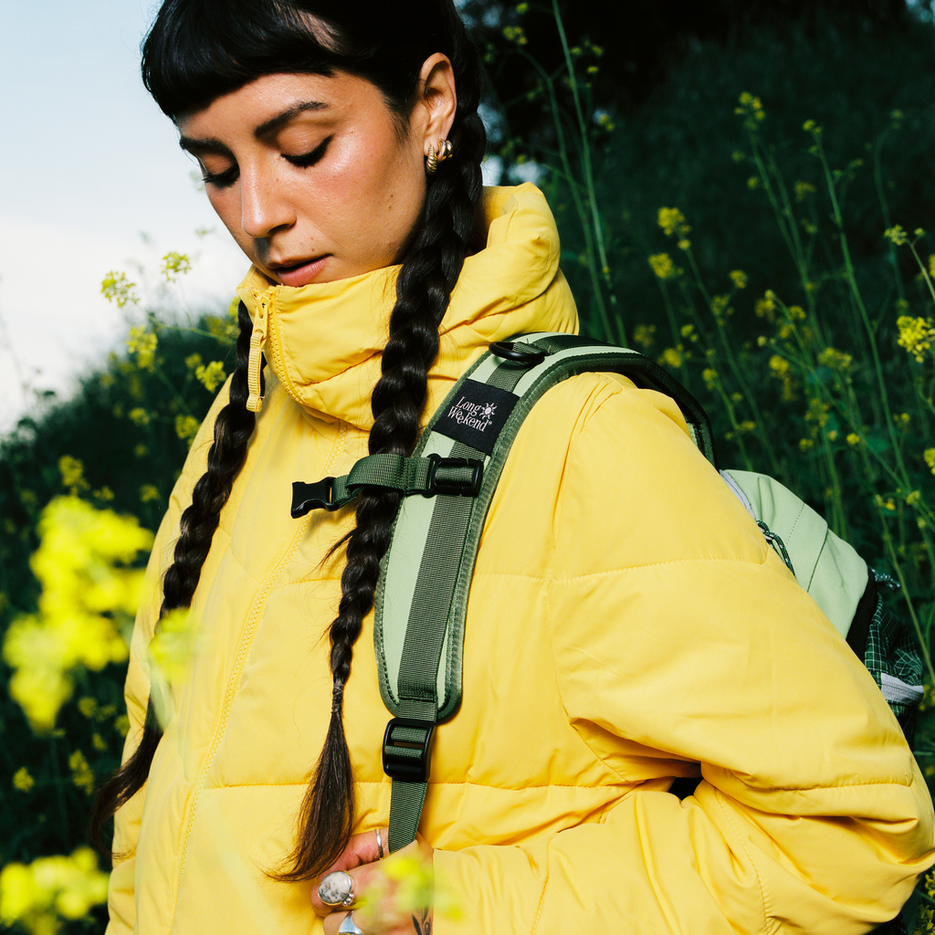Olive-green convertible backpack with adjustable shoulder straps and front logo patch