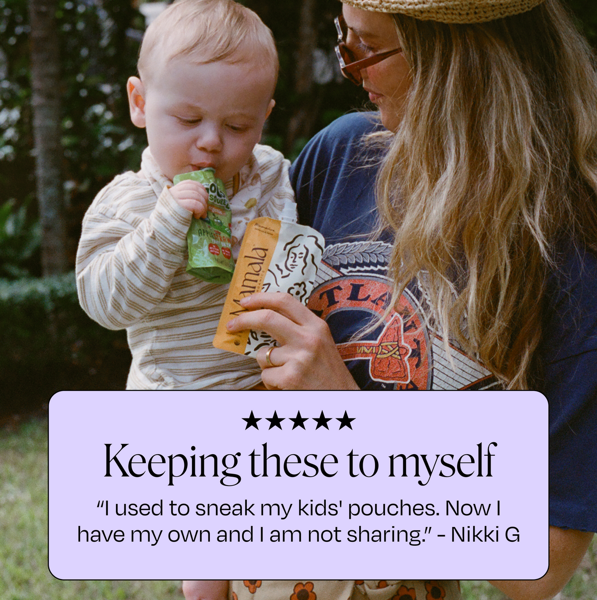 Mamamellow Support Snack™ pouch held near a baby's face, white flip-top spout