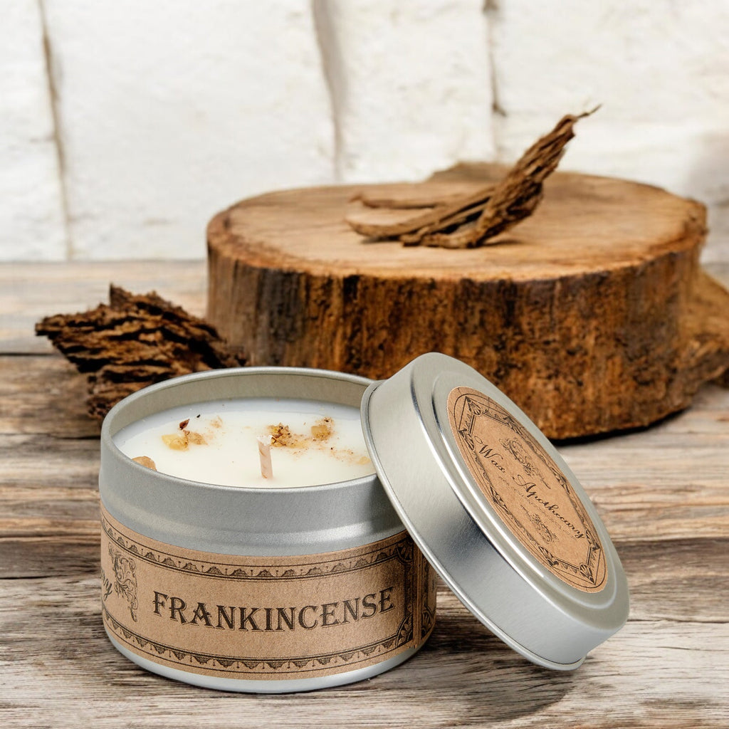 Open silver travel candle tin with white candle and botanical lid insert