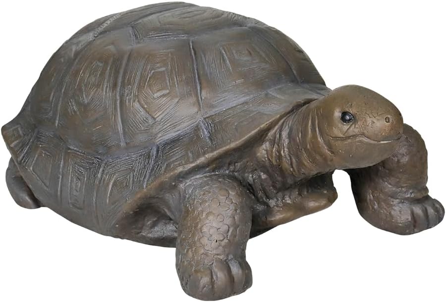 Concrete turtle garden statue close-up, dark gray shell and brownish head