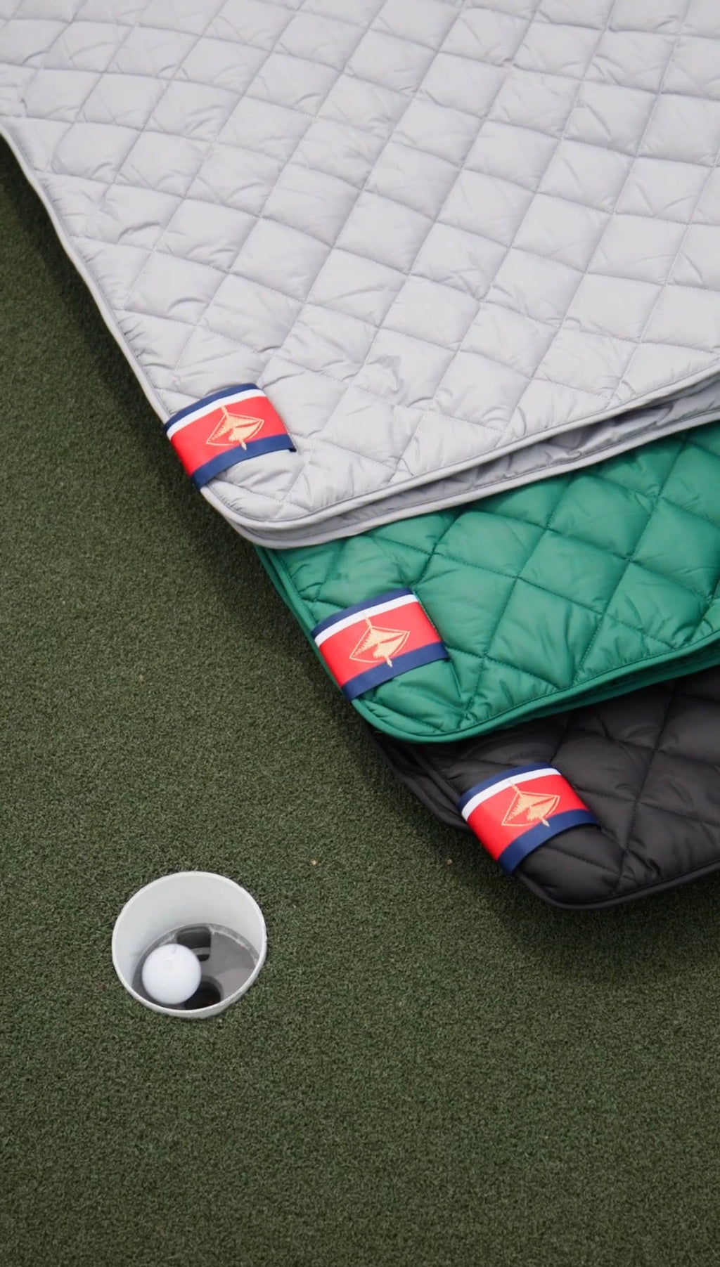 Waterproof puffer blanket with pockets, green, white and black quilted blankets with pocket labels