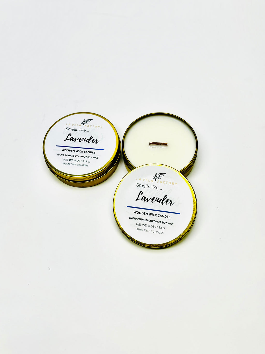 Wood-wick candle in gold and white tins; lids labeled Lavender.