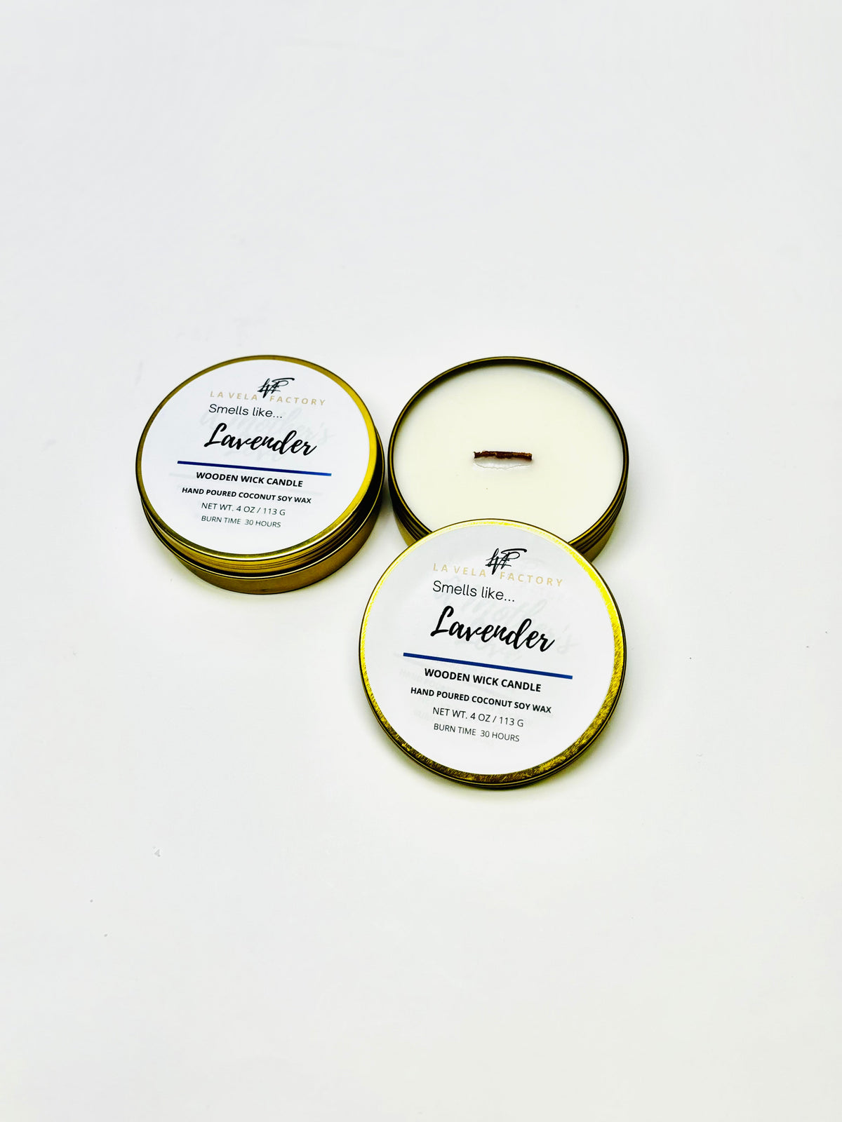 Wood-wick candle in gold and white tins; lids labeled Lavender.