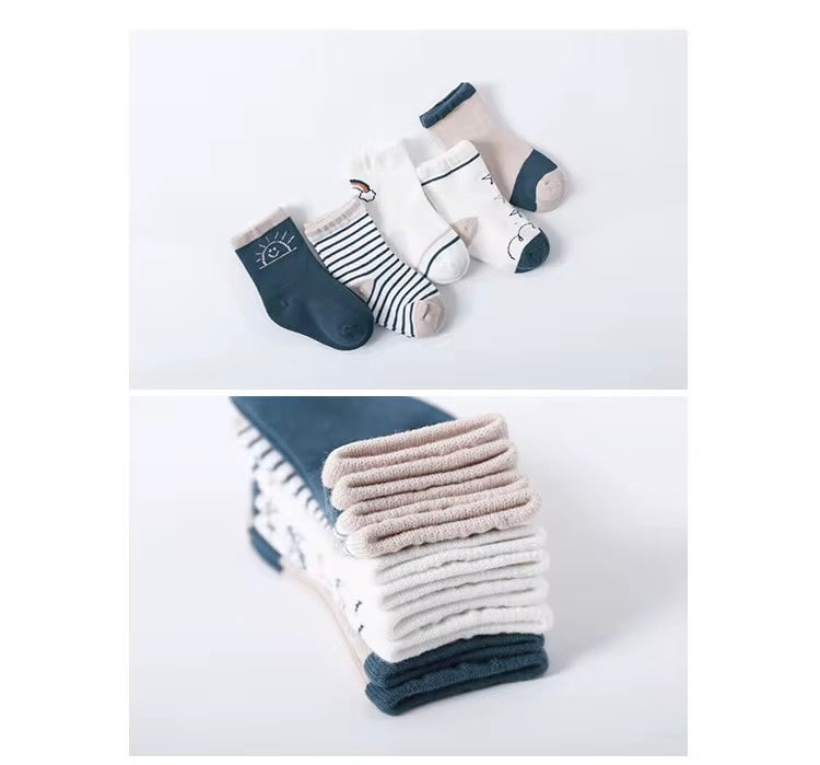 Kids socks variety with sun face, stripes, and animal motifs; stacked cuff close-up
