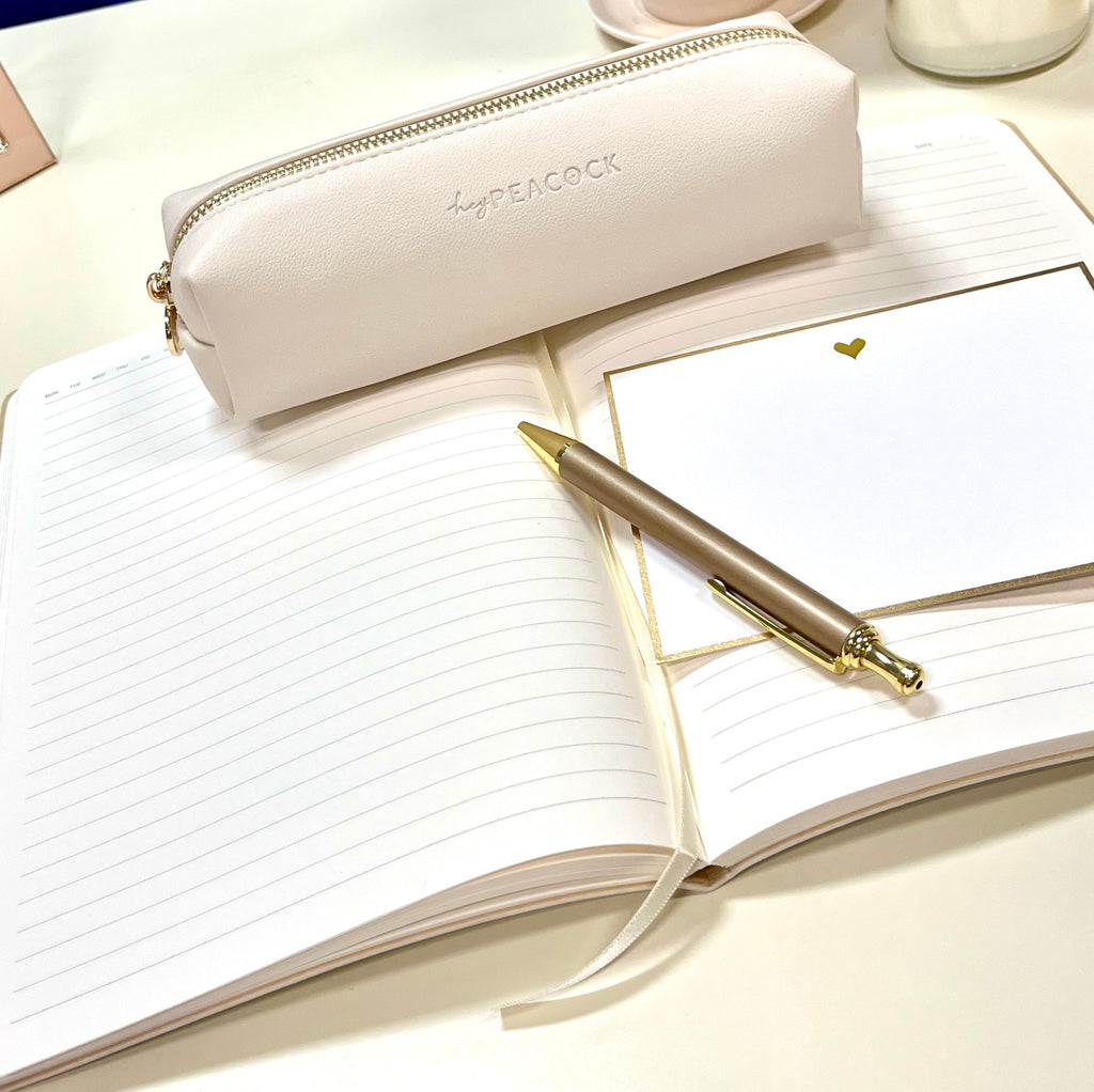 Cream HeyPeacock pencil pouch with full-length gold zipper and logo