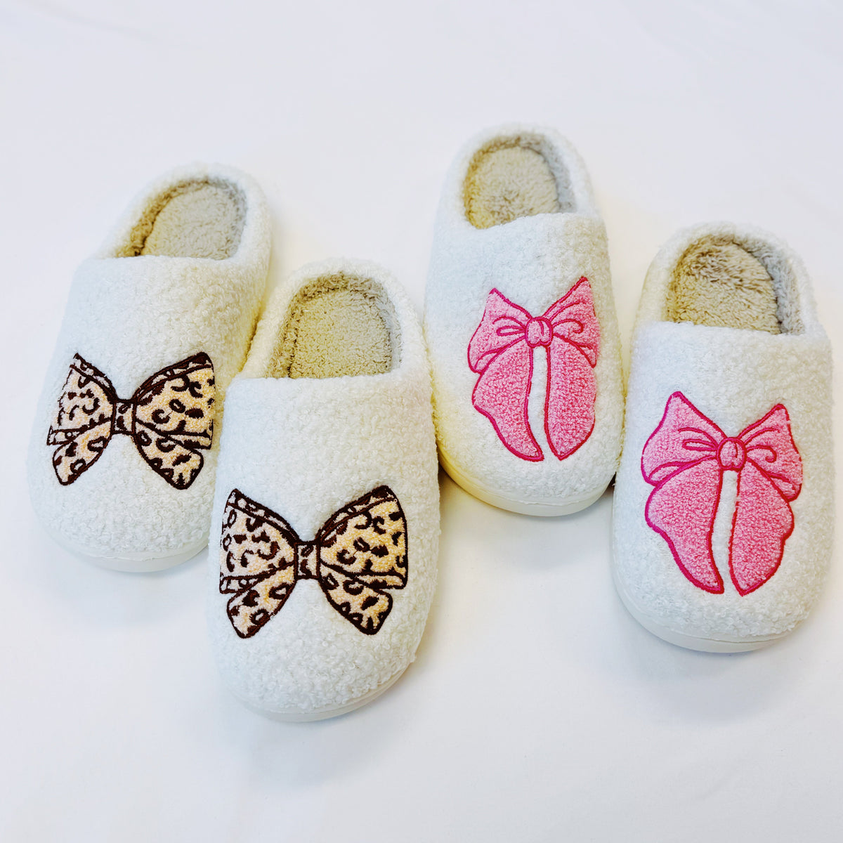 Set of cream slippers with mixed bow styles: leopard print and pink appliques